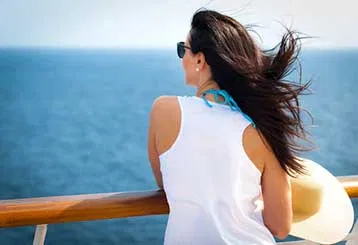 Traveler taking in the ocean from a cruise ship deck